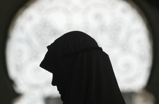 A Muslim woman prays at the Baiturrahman grand mosque in Banda Aceh